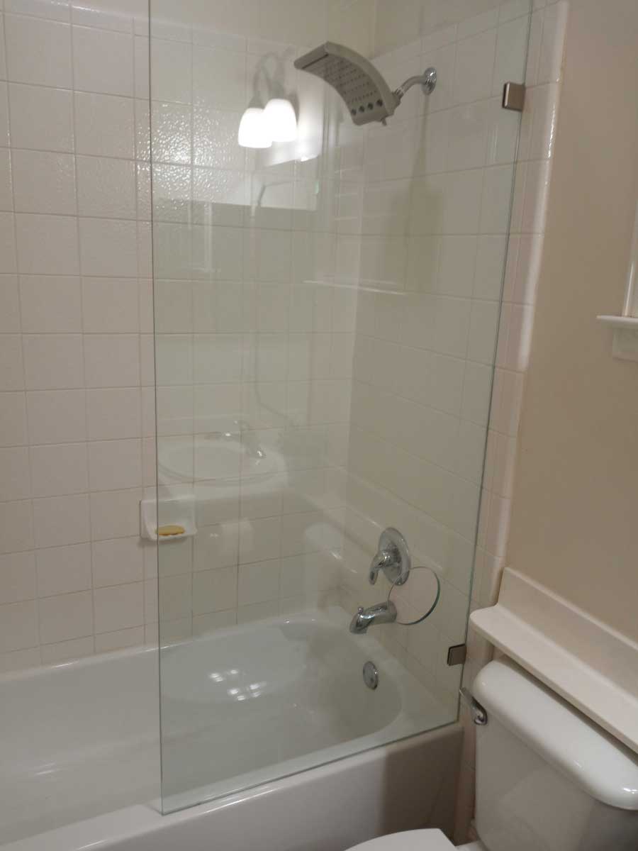 Frameless Glass Panel on bathtub with hole to turn on water